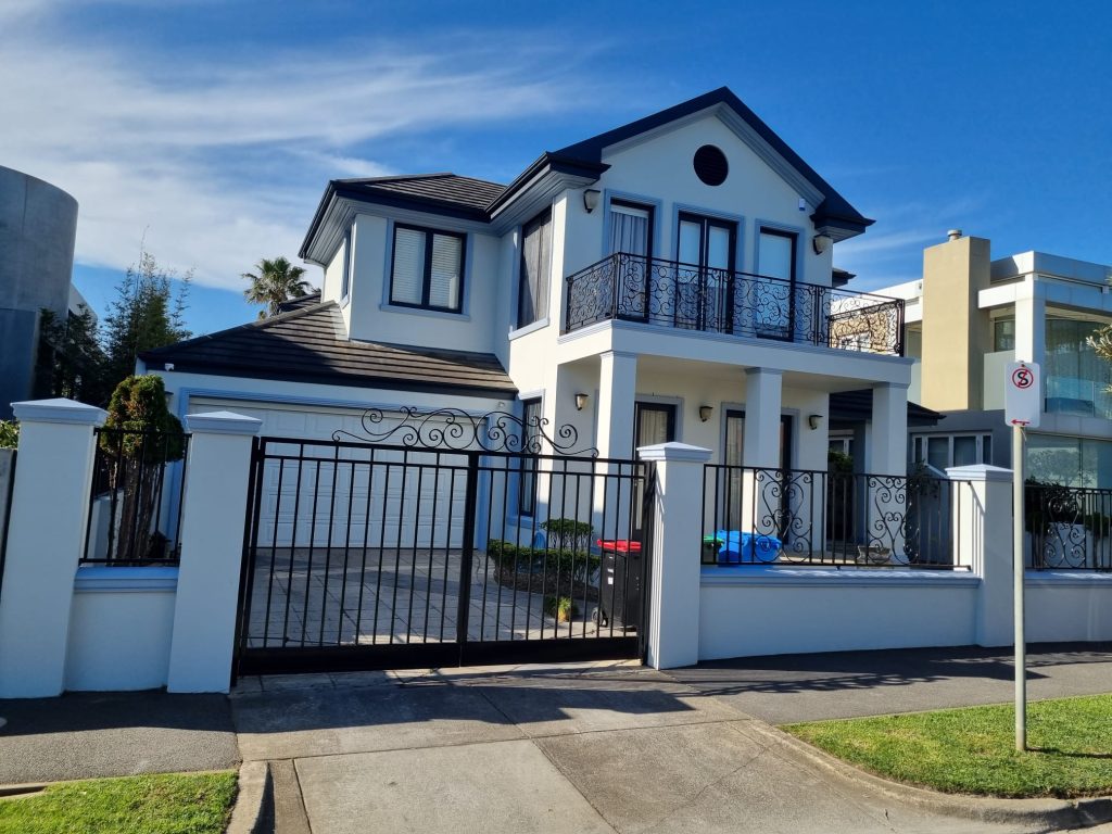 A two-storey Melbourne home with a crisp white exterior painted by Vic Diamond Painting