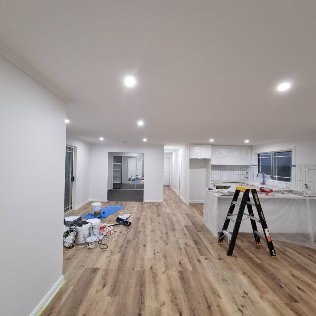 Bright open-plan interior with newly painted white walls and ceiling